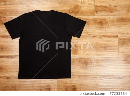 Black shortsleeve cotton tshirt on a wooden backgronud Black shortsleeve cotton tshirt on a wooden backgronud 77233584