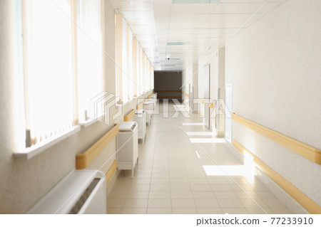 Solar bright light shining from windows of hospital corridor 77233910