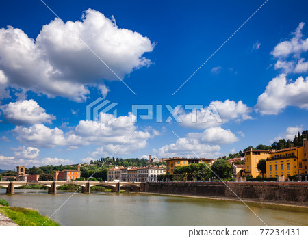 Florence cityscape with Arno River embankment and Ponte alle Grazie bridge Tuscany Italy 77234431