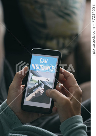 man searches a car insurance on his smartphone man searches a car insurance on his smartphone 77234558