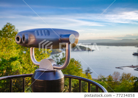 Tourist telescope over Oslo cityscape at sunset Norway 77234858