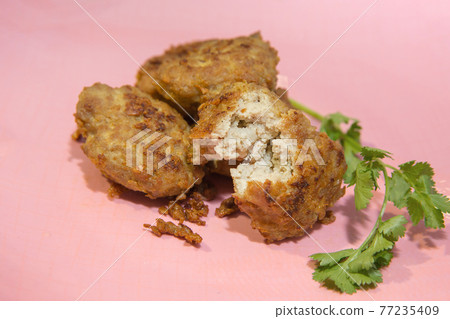 Fried Pork chop Cake with garlic and pepper eat with coriander, focus selective. Fried Pork chop Cake with garlic and pepper eat with coriander, focus selective. 77235409