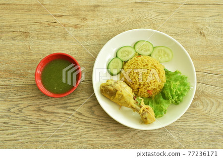rice cooked with chicken in curry on plate dipping spicy chili sauce 77236171