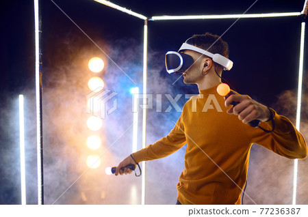 Gamer plays the game using virtual reality headset Gamer plays the game using virtual reality headset 77236387