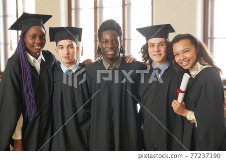 A group of people wearing graduation gowns and caps 77237190