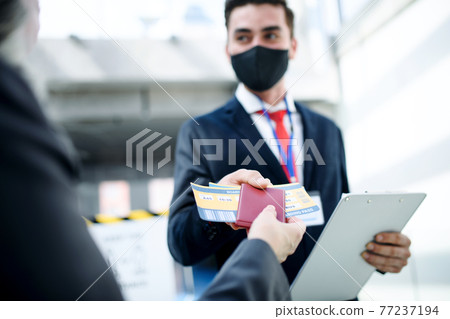 Senior woman with boarding pass at the gate in airport, coronavirus, travel, and new normal. Senior woman with boarding pass at the gate in airport, coronavirus, travel, and new normal. 77237194