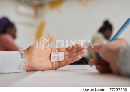 Student hiding note at exam Student hiding note at exam 77237268