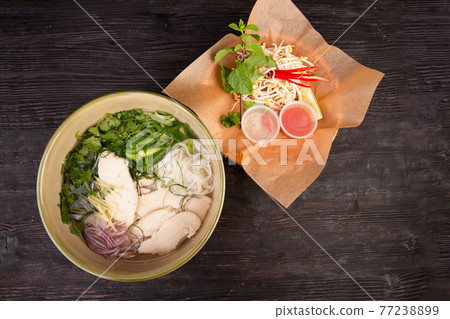 turkey soup, served with rice noodles, fresh greens, red onions and Chilean pepper turkey soup, served with rice noodles, fresh greens, red onions and Chilean pepper 77238899