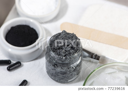 Ingredients for a homemade charcoal facial mask. 77239616