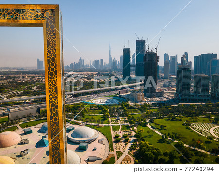Dubai skyline seen through Dubai Frame building with Zabeel park and Dubai skyline aerial cityscape view of the Emirate 77240294