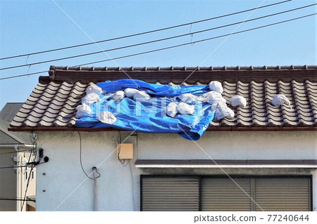 Roof tiles damaged by typhoon 77240644