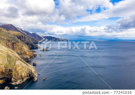 Aerial view of the beautiful coast at Malin Beg with Slieve League in the background in County Donegal, Ireland Aerial view of the beautiful coast at Malin Beg with Slieve League in the background in County Donegal, Ireland 77241016