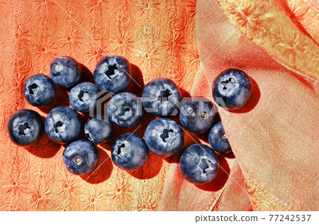 Blackberries on orange background Blackberries on orange background 77242537