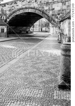 Cobbled street under the bridge 77243149