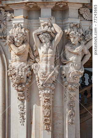 Ancient sculpture of funny, tricky and joyful dickens in historical downtown of Dresden, Germany, details, closeup. Concept of art and historical heritage. Ancient sculpture of funny, tricky and joyful dickens in historical downtown of Dresden, Germany, details, closeup. Concept of art and historical heritage. 77243665
