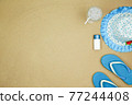 top view a hat , sunglasses ,shoes and water drink on sand beach. 77244408