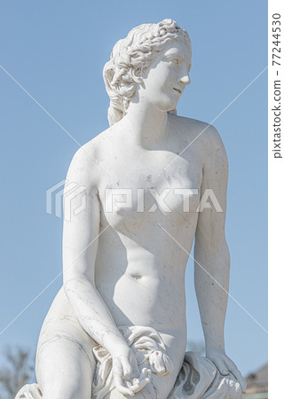 Old statue of a sensual naked Renaissance Era woman in the park of Potsdam, Germany, details, closeup 77244530