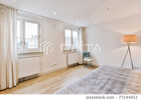 Spacious light bedroom at home 77244852