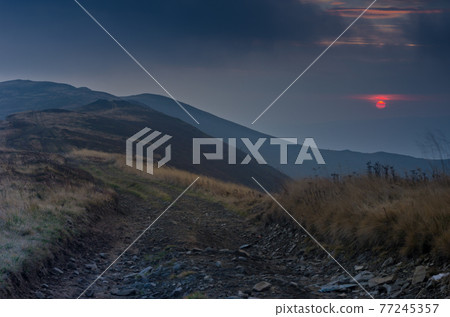 Night in the mountains. Sunset. The sky is the color of blood. Outdoor. Night in the mountains. Sunset. The sky is the color of blood. Outdoor. 77245357