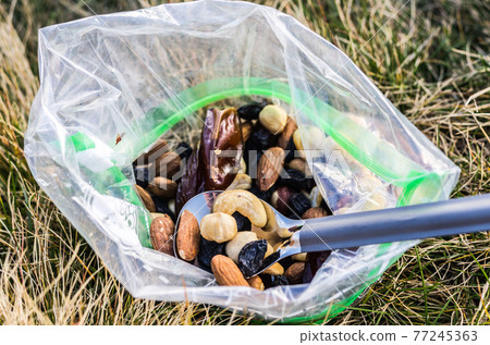 A lot of different nuts. Tourist snack. Energy for the tourist. A lot of different nuts. Tourist snack. Energy for the tourist. 77245363