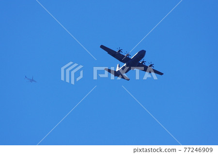Transport planes and civilian planes flying in the blue sky 77246909