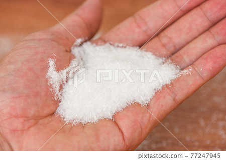 Monosodium glutamate on hand, MSG for food seasoning 77247945