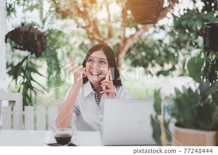 Woman using mobile phone and working at home,Work from home,New normal concept Woman using mobile phone and working at home,Work from home,New normal concept 77248444