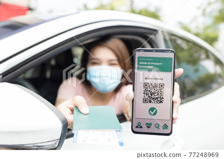 asian woman shows health passport asian woman shows health passport 77248969
