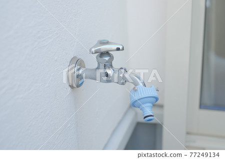 A faucet attached to the balcony of a house A faucet attached to the balcony of a house 77249134