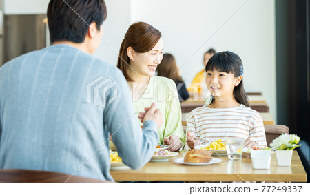 Young family eating at a family restaurant 77249337