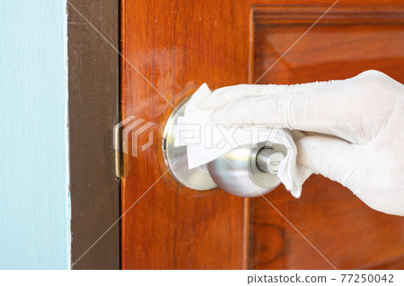 Prevention cleaning Door handles by Disinfectant solution for killing corona virus on touching surfaces, concept coronavirus COVID19 Prevention cleaning Door handles by Disinfectant solution for killing corona virus on touching surfaces, concept coronavirus COVID19 77250042