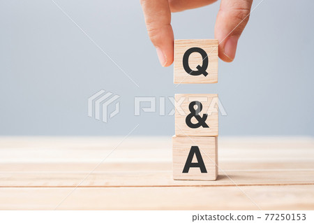 Hand holding Q and A word with wooden cube block. FAQ( frequency asked questions), Answer, Question  Ask, Information, Communication and Brainstorming Concepts 77250153