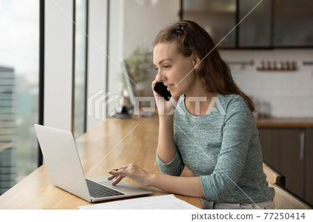 Caucasian female employee consult client on cellphone call 77250414