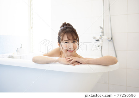 Cute woman taking a bath Cute woman taking a bath 77250596