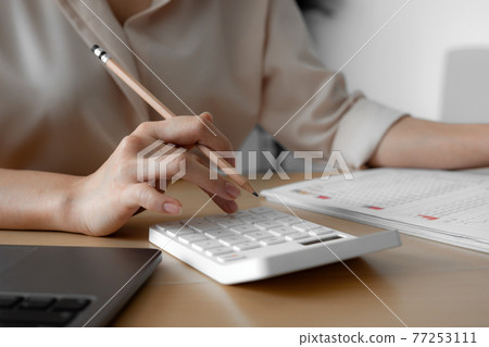 Close up of Businessperson's Hand Calculating Bill, budget, monthly report With Calculator, Business Accounting Saving Concept Close up of Businessperson's Hand Calculating Bill, budget, monthly report With Calculator, Business Accounting Saving Concept 77253111