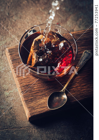 Tea bag in a glass cup 77253941