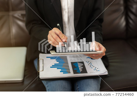 Businessman using tablet and stock market charts. Financial concept. Businessman using tablet and stock market charts. Financial concept. 77254460