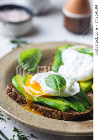 Toasted bread with poached egg Toasted bread with poached egg 77254694
