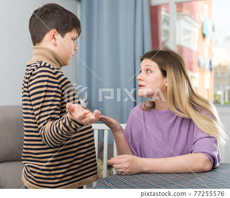 Offended son and unhappy mom having quarrel in home 77255576