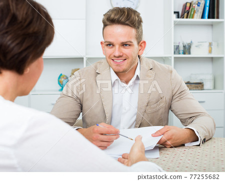 man tells woman about interesting offers 77255682