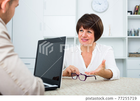 Adult blond man and businesswoman communicate 77255719