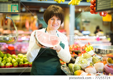 Adult female selling watermelon Adult female selling watermelon 77255724