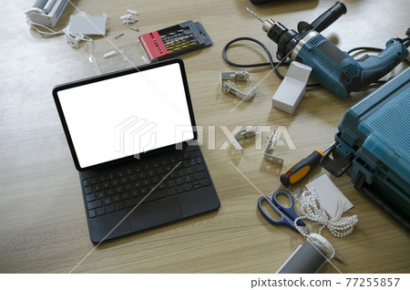 Above view of computer tablet with empty screen and construction tools wooden floor. 77255857
