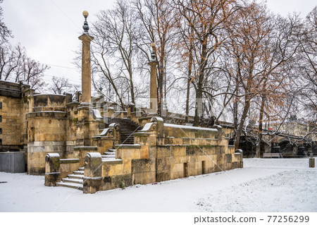 Stone brige staircase covered by snow 77256299