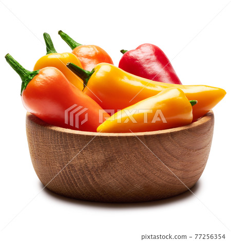 Wooden bowl full of Chili or sweet peppers isolated on white background Wooden bowl full of Chili or sweet peppers isolated on white background 77256354