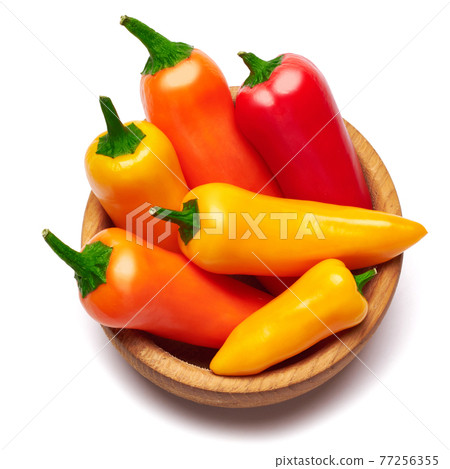 Wooden bowl full of Chili or sweet peppers isolated on white background Wooden bowl full of Chili or sweet peppers isolated on white background 77256355