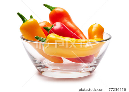 Glass bowl full of Chili or sweet peppers isolated on white background Glass bowl full of Chili or sweet peppers isolated on white background 77256356
