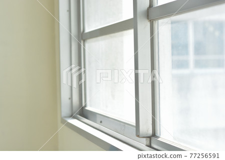The aluminum sash window of the school building where light shines in from the outside The aluminum sash window of the school building where light shines in from the outside 77256591