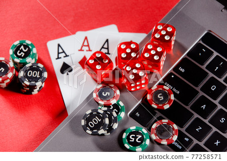 Red playing dice, gambling chips and cards with aces. Online casino theme Red playing dice, gambling chips and cards with aces. Online casino theme 77258571