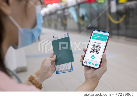 asian woman shows health passport 77259065